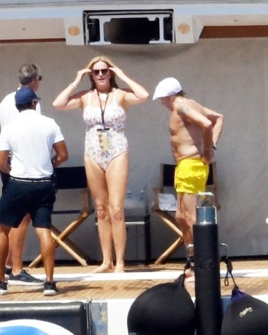 Elba, ITALY  - *EXCLUSIVE*  - Sir Rod Stewart, 77, and wife Penny Lancaster, 51, enjoy the Tuscan Sun while vacationing on Elba Island. 

Rod has been enjoying his vacation with wife of 15 years, Penny and their son. Rod still very much a gentleman, was seen extending his hand to Penny to help her as she climbed up the ladder after a dip in the sea.  On Monday the superstar shared a family photo with 7 of his 8 children.
The Downtown Train singer was spotted relaxing while enjoying a day aboard the St. David on the Mediterranean. The super yacht comes with every luxury amenity including fully equipped gym, jacquzzi, and tons of toys at the ready including wave runners, sea bobs, wakeboards, kayaks and of course an large inflatable raft which Rod seemed to enjoy quite a bit!

Pictured: Rod Stewart, Penny Lancaster 

BACKGRID USA 4 AUGUST 2022 

USA: +1 310 798 9111 / usasales@backgrid.com

UK: +44 208 344 2007 / uksales@backgrid.com

*UK Clients - Pictures Containing Children
Please Pixelate Face Prior To Publication*