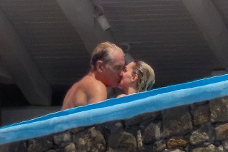 EXCLUSIVE: Swedish actor Dolph Lundgren goes shirtless during a romantic vacation in Greece with his much younger fiancee Emma Krokdal amid his lengthy cancer battle. The 65-year-old movie star and the 25-year-old Norwegian beauty were seen kissing as they enjoyed a sunsoaked break in Mykonos. The trip comes after the 'Rocky IV' star revealed he has been battling lung cancer for eight years and speculated whether his past use of steroids for bodybuilding is to blame. The couple were joined in Greece by Dolph's model daughter Ida Lundgren, 27. Despite their 40-year age gap, Dolph has spoken about how mature his lady love is for her age. 13 Jul 2023 Pictured: Dolph Lundgren, Emma Krokdal. Photo credit: A LONE WOLF/MEGA TheMegaAgency.com +1 888 505 6342 (Mega Agency TagID: MEGA1006850_001.jpg) [Photo via Mega Agency]