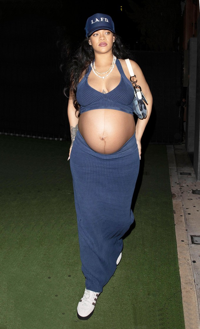 Rihanna Shows Off Her Baby Bump In A Crop Top & Skirt