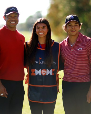 ORLANDO, FLORIDA - DECEMBER 22: Tiger Woods of the United States with his son Charlie Woods and daughter Sam Woods stand on the first tee during the second round of the PNC Championship at Ritz-Carlton Golf Club on December 22, 2024 in Orlando, Florida. (Photo by Mike Ehrmann/Getty Images)