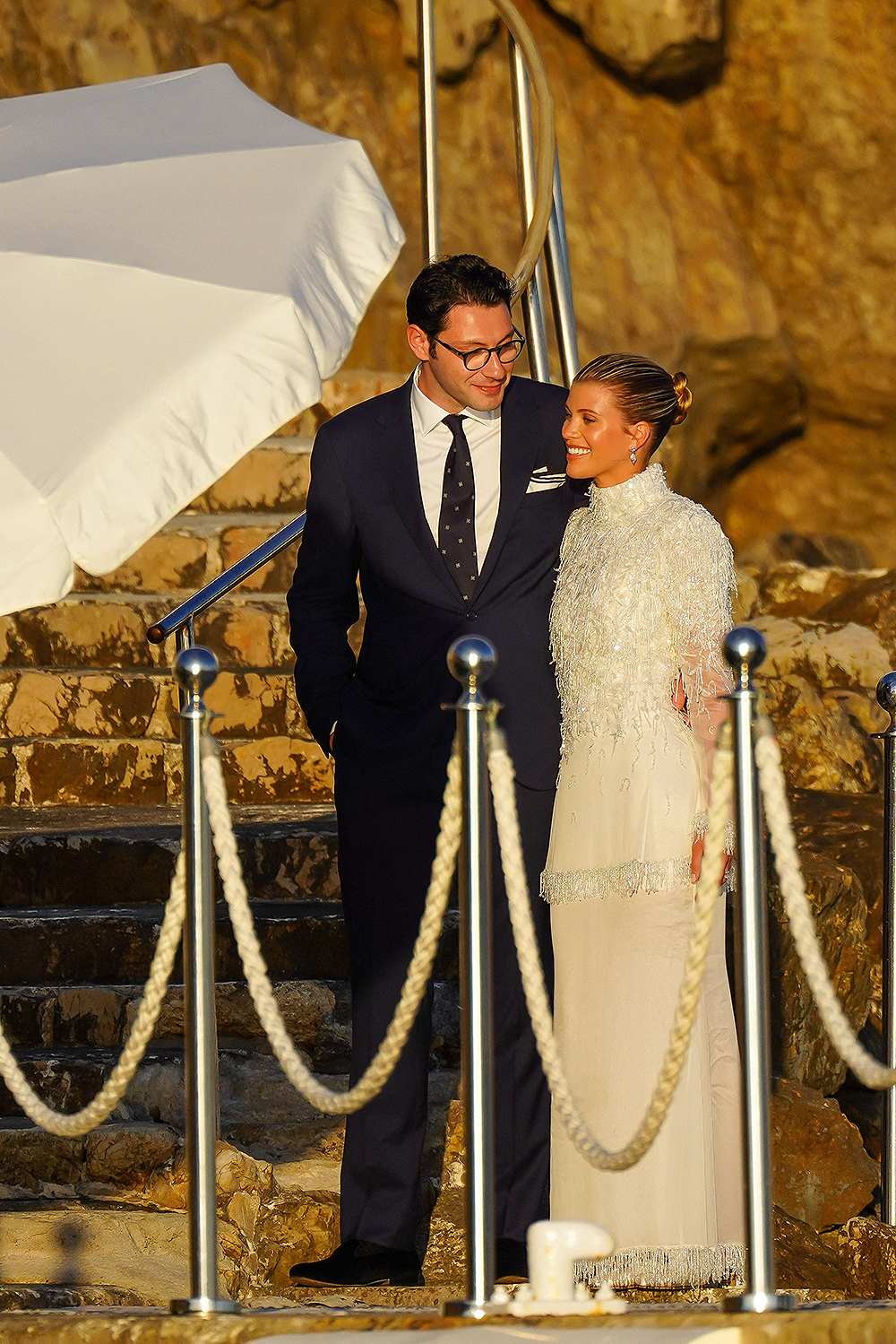 Blushing bride Sofia Richie looks radiant in an elegant white gown as she celebrates her lavish wedding weekend in the French Riviera.