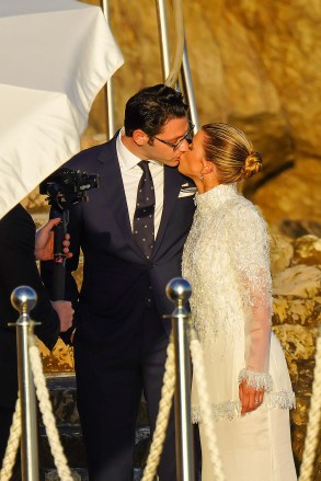 Blushing bride Sofia Richie looks radiant in an elegant white gown as she celebrates her lavish wedding weekend in the French Riviera. The model and daughter of legendary crooner Lionel Richie stepped out with her British fiance Elliot Grainge on Friday evening during their ultra glamorous trip to tie the knot in Antibes. It was unclear whether the happy couple were heading off to a fancy rehearsal dinner, or were dressed up for the nuptials. The stylish 24-year-old chose a demure, delicately beaded floor length ensemble for the occasion paired with white stilettos and wore her long hair in a chic up do. Her record executive groom, 30, looked dapper in a dark suit and tie as they were snapped by their team of photographers at their swanky hotel at sunset. Among the slew of A-list guests jetting in to watch them exchange vows are Cameron Diaz and Benji Madden, Sofia’s sister Nicole Richie and husband Joel Madden, as well as her father Lionel Richie and brother Miles. 21 Apr 2023 Pictured: Sofia Richie , Elliot Grainge. Photo credit: EliotPress / MEGA TheMegaAgency.com +1 888 505 6342 (Mega Agency TagID: MEGA971732_001.jpg) [Photo via Mega Agency]