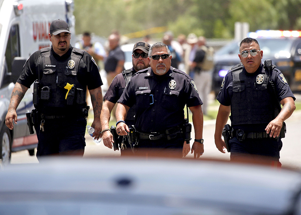 Police walk near Robb Elementary School following a shooting, in Uvalde, Texas
Texas School-Shooting, Uvalde, United States - 24 May 2022