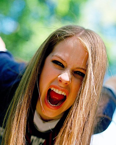 LAVIGNE Singer Avril Lavigne gestures during a photo session in New York's Central Park . A new crop of female singer-songwriters like Lavigne are challenging the notion that you have to bare your navel and cavort around in tight clothes to be sexy. Over the last year, artists like Pink, Michelle Branch, Vanessa Carlton and Lavigne have been dominating the charts with by putting the focus on their music, and not their looksMUSIC AVRIL LAVIGNE, NEW YORK, USA