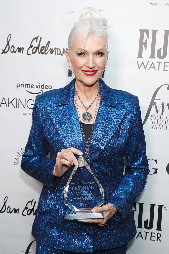 Maye Musk holding an award