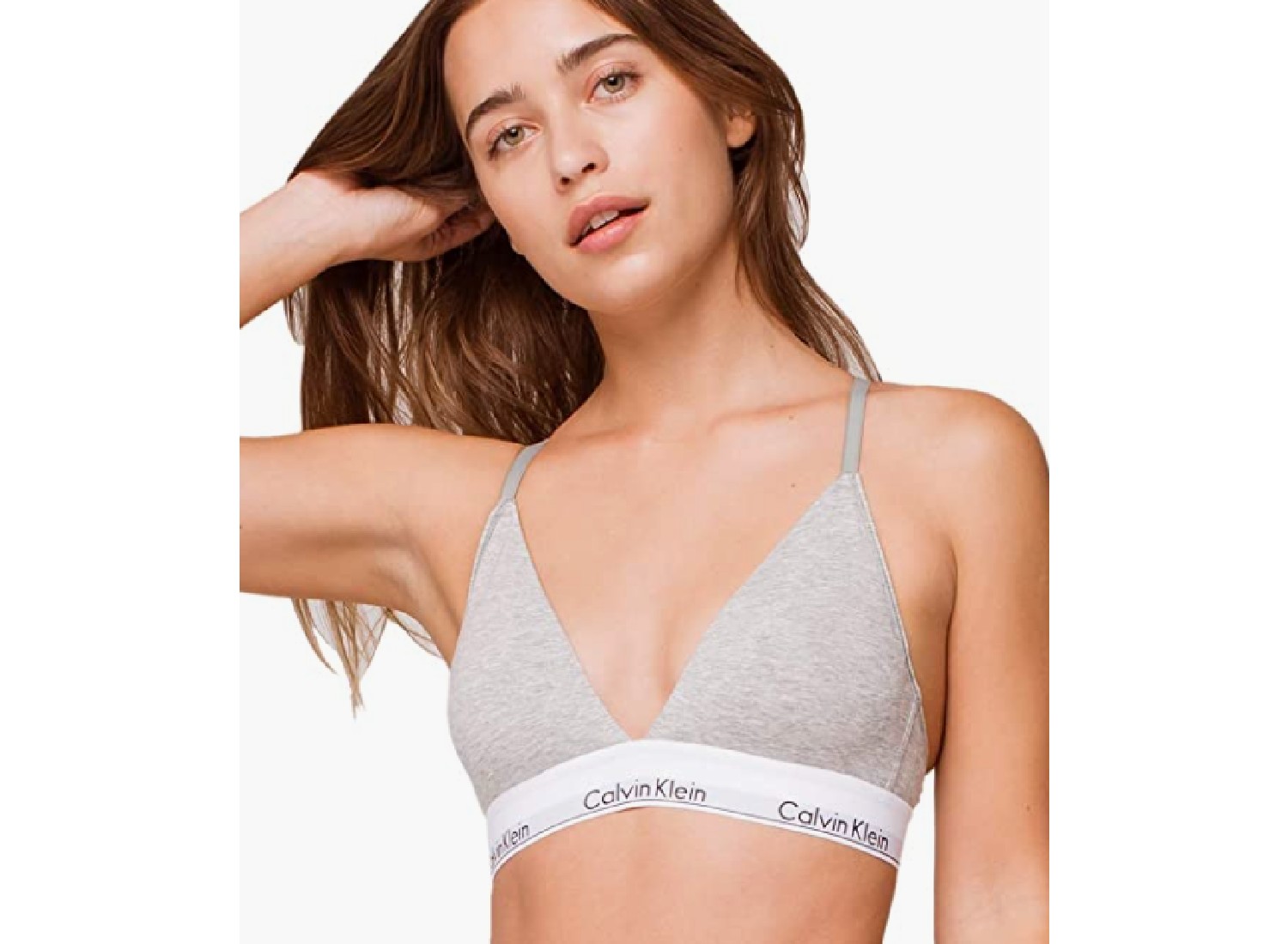 A woman wearing a grey bralette.