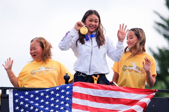 Suni Lee Shows Her Gold Medal in Parade