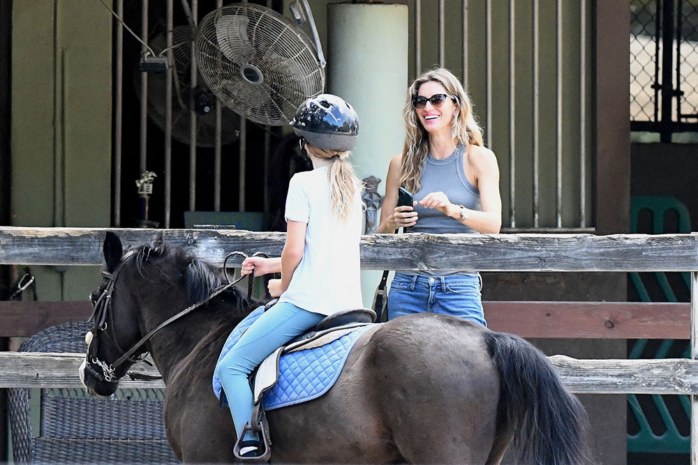 EXCLUSIVE: Newly single Gisele Bundchen looks happy as she takes her daughter Vivian to a riding lesson in Miami