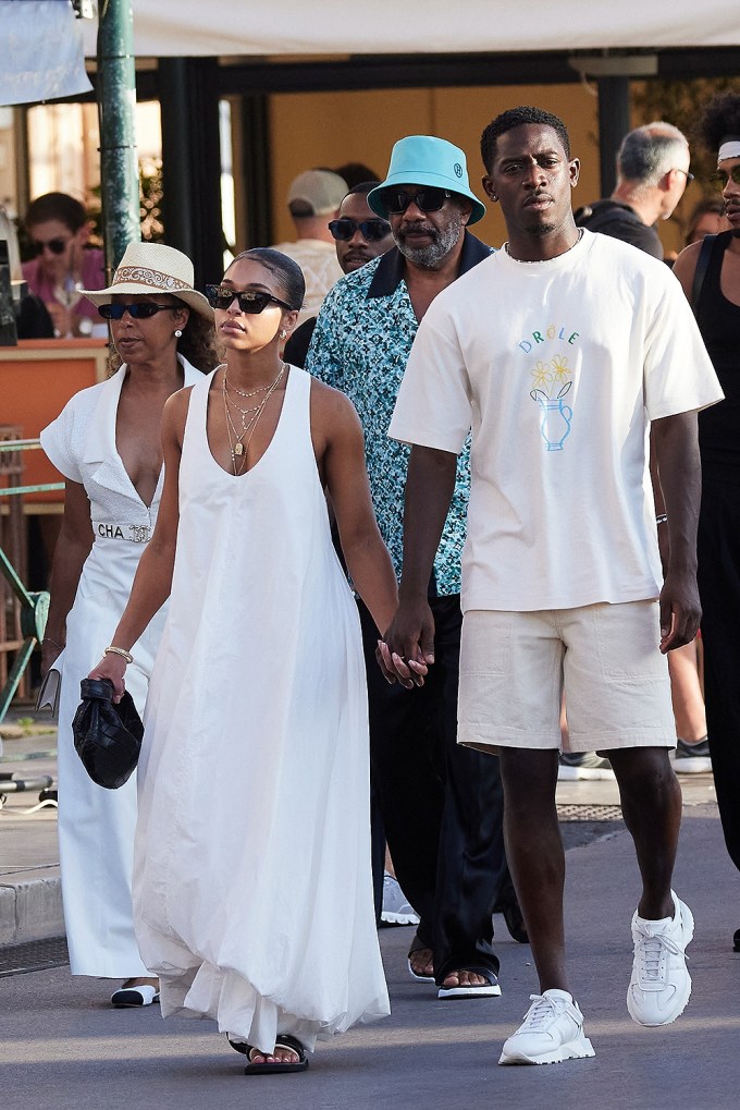 Damson Idris and Lori Harvey holding hands