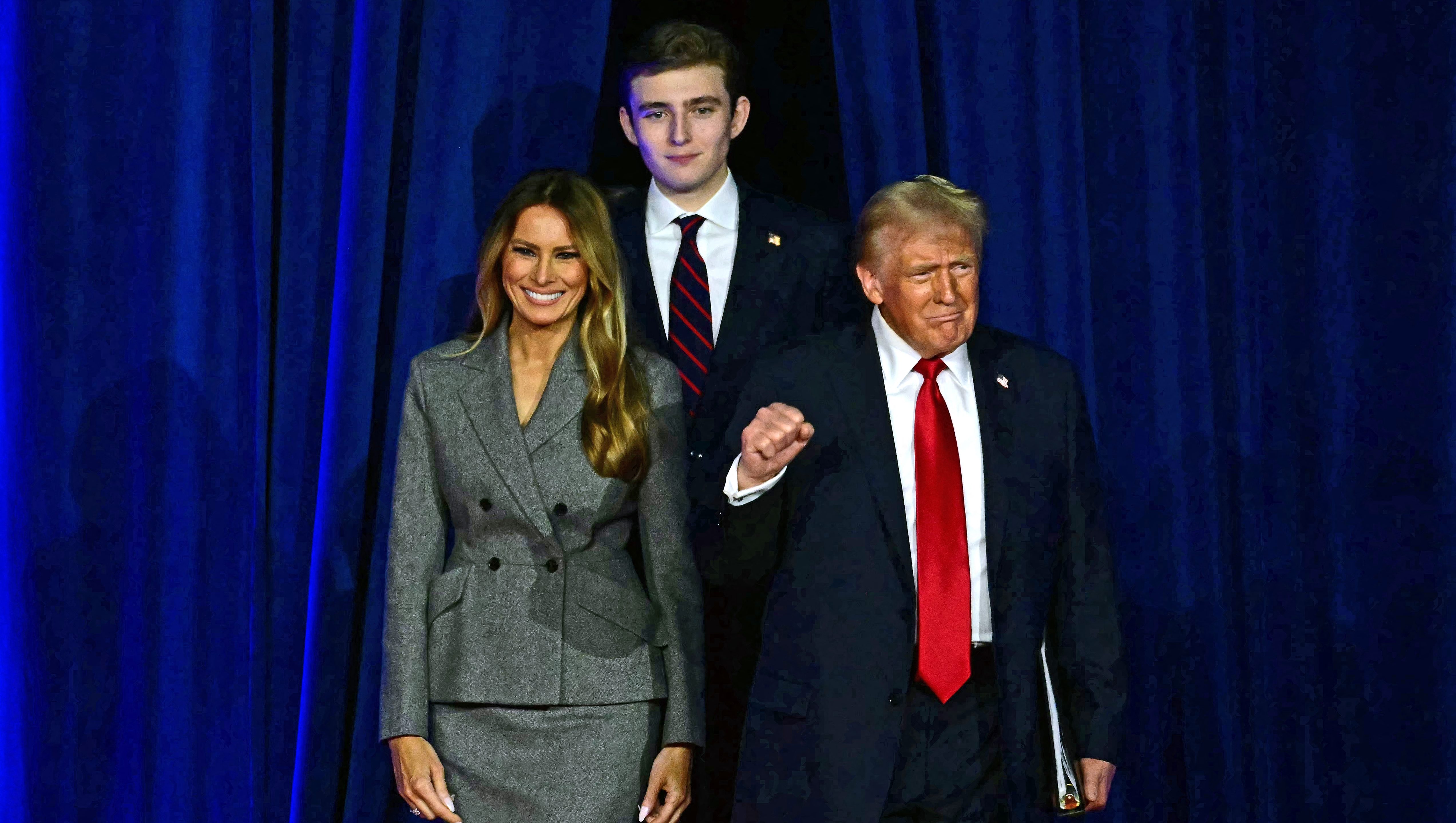 TOPSHOT - Former US President and Republican presidential candidate Donald Trump (R) arrives for  an election night event alongside former US First Lady Melania Trump and his son Barron Trump at the West Palm Beach Convention Center in West Palm Beach, Florida, on November 6, 2024. (Photo by Jim WATSON / AFP) (Photo by JIM WATSON/AFP via Getty Images)