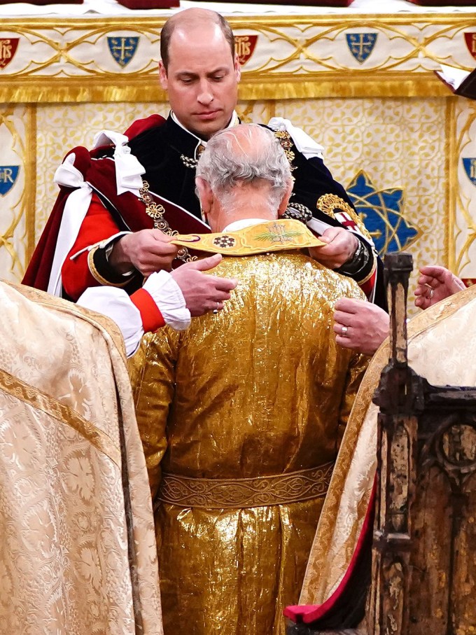 Prince William Puts A Robe On His Dad