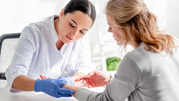 Doctor checking patient's skin