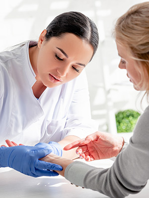 Doctor checking patient's skin