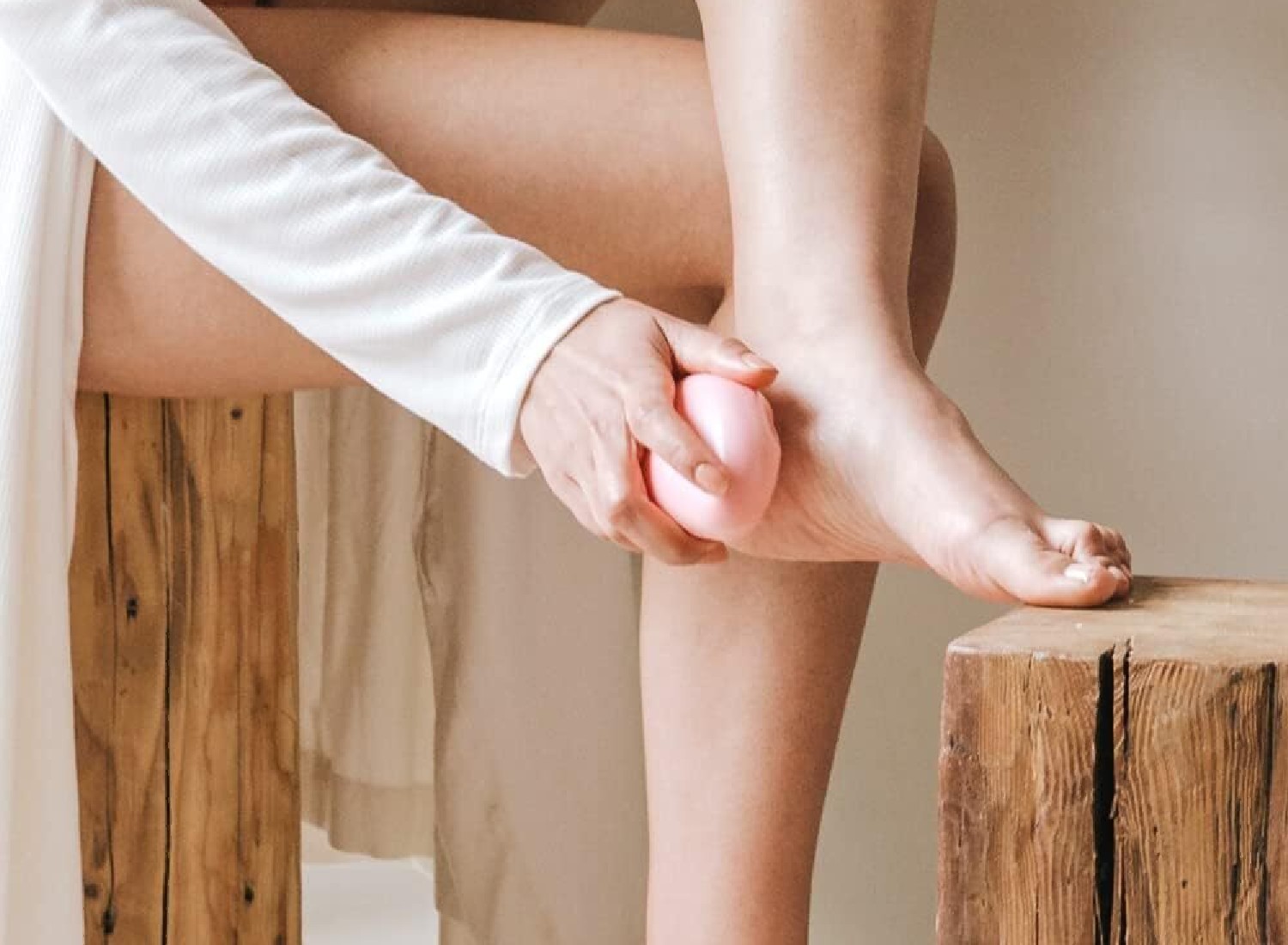 A woman buffs her feet with a foot scrub