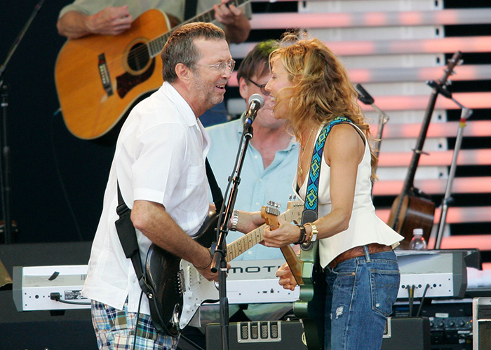 Eric Clapton and Sheryl Crow performing on stage 