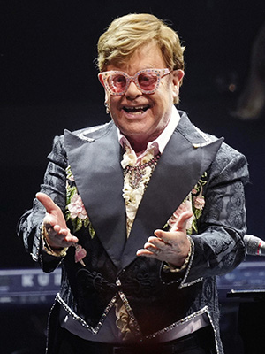 Elton John performing on tour
