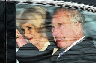 Britain's King Charles III and Britain's Queen Camilla wave as they leave by car from Clarence House in London on February 6, 2024. King Charles III's estranged son Prince Harry reportedly arrived in London on Tuesday after his father's diagnosis of cancer, which doctors "caught early". (Photo by HENRY NICHOLLS / AFP) (Photo by HENRY NICHOLLS/AFP via Getty Images)