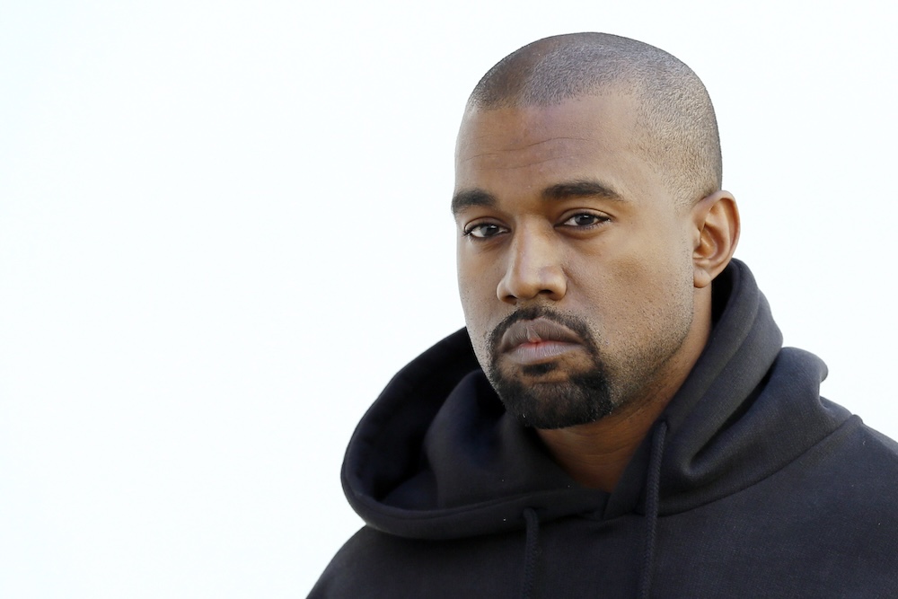 Kanye West poses before Christian Dior 2015-2016 fall/winter ready-to-wear collection fashion show 