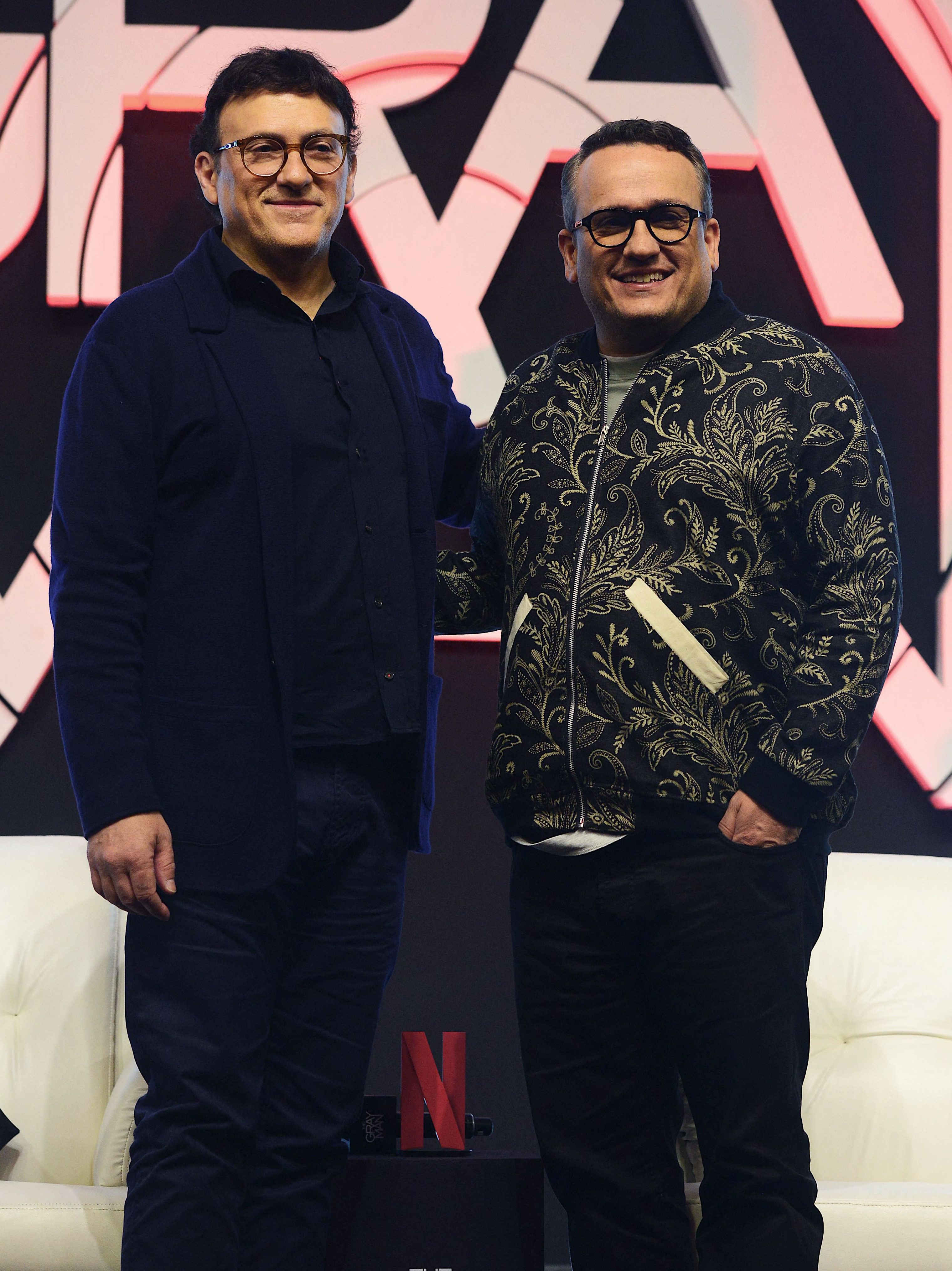 Movie directors and producers Joseph Russo (R) and his brother Anthony Russo pose for pictures during the press conference for their upcoming action thriller movie The Gray Man in Mumbai on July 21, 2022. (Photo by SUJIT JAISWAL / AFP) (Photo by SUJIT JAISWAL/AFP via Getty Images)