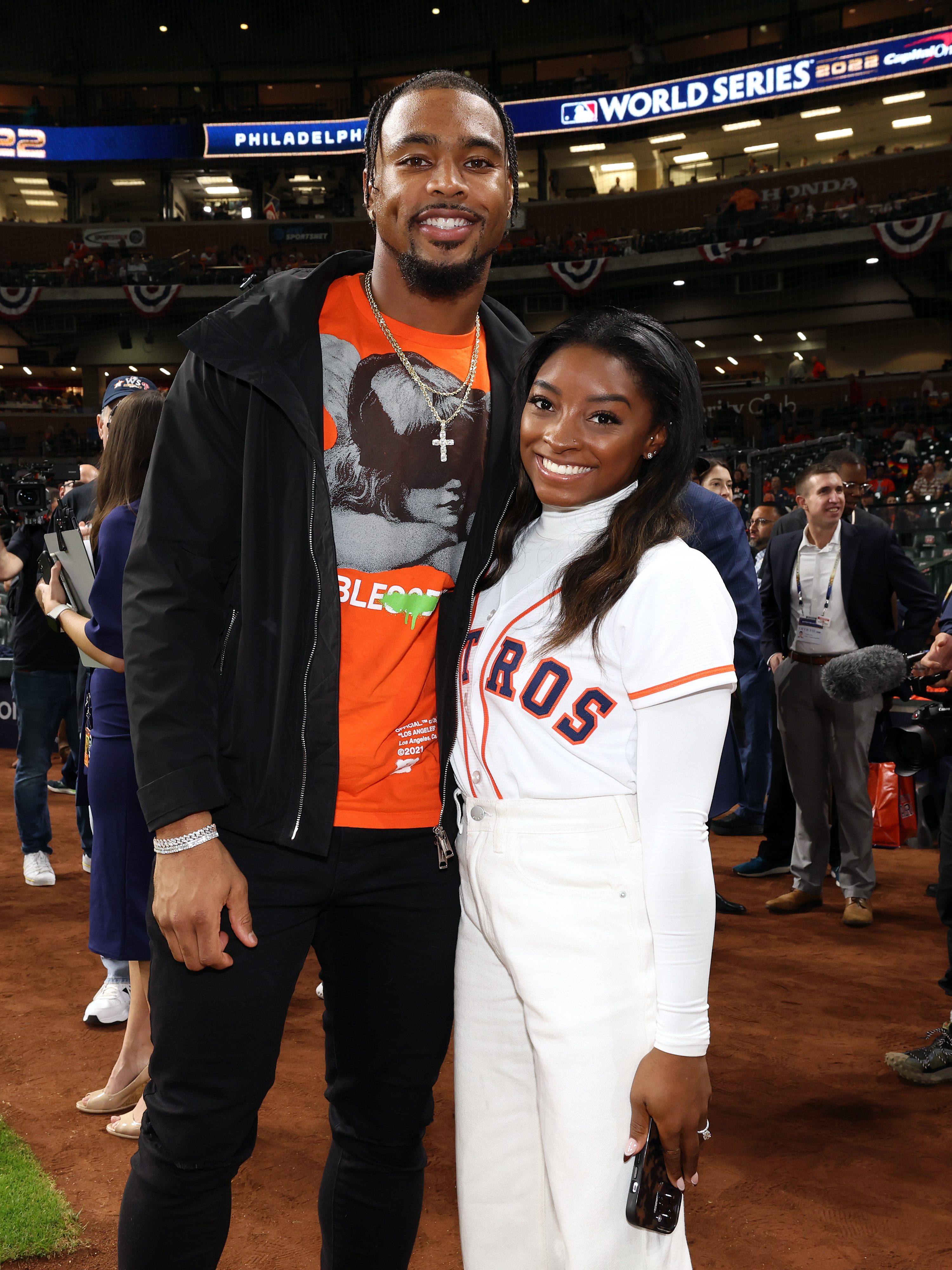 HOUSTON, TX - OCTOBER 28:  Olympic gold medalist Simone Biles and Houston Texans safety Jonathan Owens are seen prior to Game 1 of the 2022 World Series between the Philadelphia Phillies and the Houston Astros at Minute Maid Park on Friday, October 28, 2022 in Houston, Texas. (Photo by Mary DeCicco/MLB Photos via Getty Images)