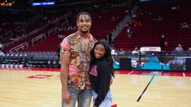 HOUSTON, TEXAS - DECEMBER 28: Simone Biles and Jonathan Owens attend a game between the Houston Rockets and the Los Angeles Lakers at Toyota Center on December 28, 2021 in Houston, Texas. NOTE TO USER: User expressly acknowledges and agrees that, by downloading and or using this photograph, User is consenting to the terms and conditions of the Getty Images License Agreement. (Photo by Carmen Mandato/Getty Images)