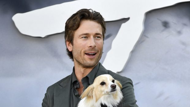 Glen Powell and his dog Brisket attend Universal's "Twisters" premiere at the Regency Village theatre