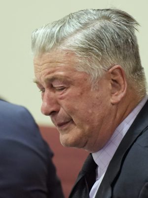 SANTA FE, NEW MEXICO - JULY 12: Alec Baldwin reacts as he sits between his attorneys Alex Spiro (L) and Luke Nikas (R) at the conclusion of his trial for involuntary manslaughter in First Judicial District Court on July 12, 2024 in Santa Fe, New Mexico. The trial for involuntary manslaughter was dismissed by a judge Friday after she ruled that key evidence over a fatal shooting on the set of "Rust" had been withheld from the defense. (Photo by Ramsay de Give-Pool/Getty Images)