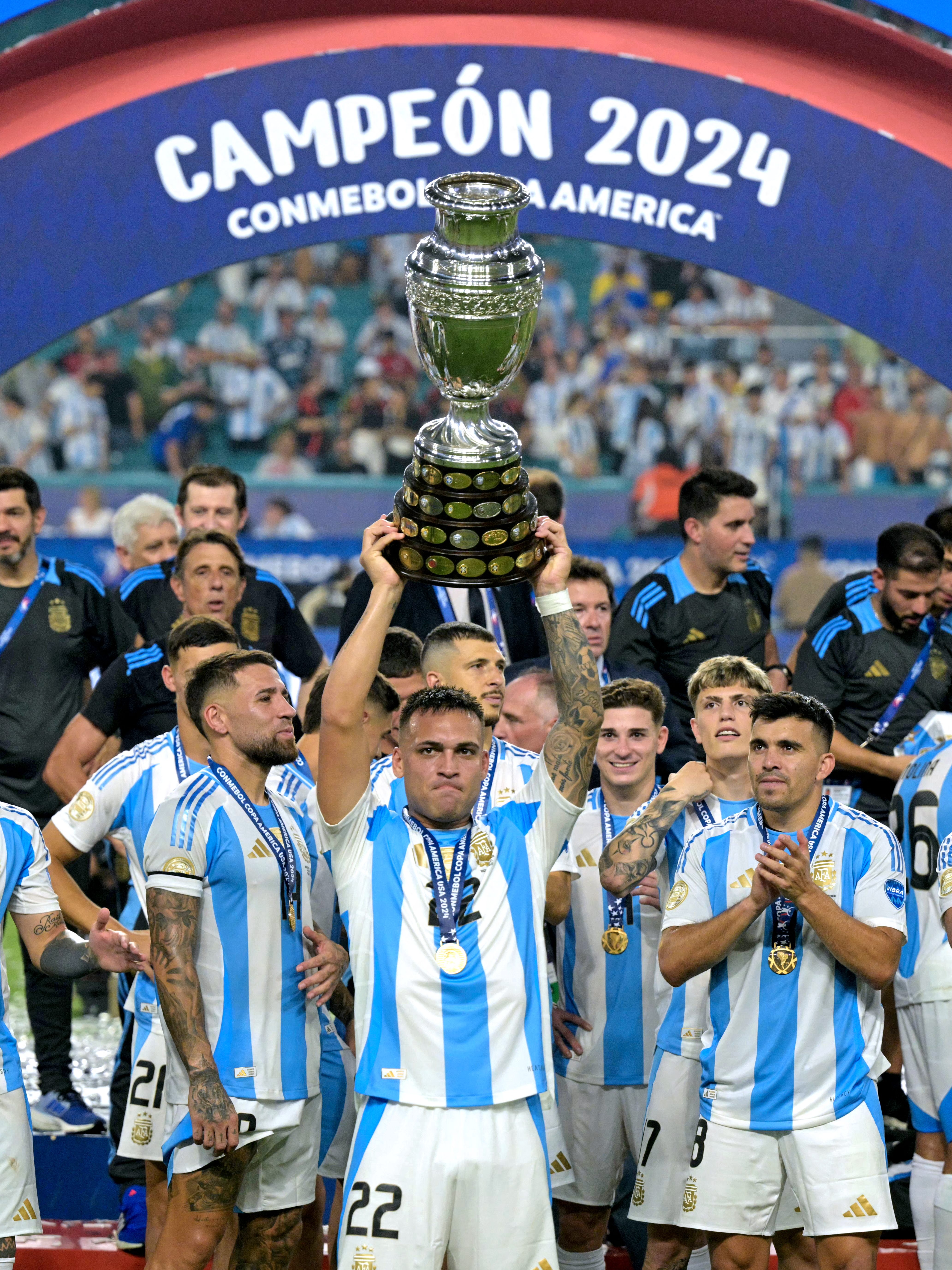 Argentina's forward #22 Lautaro Martinez lifts up the trophy as he celebrates winning the Conmebol 2024 Copa America tournament final football match between Argentina and Colombia at the Hard Rock Stadium, in Miami, Florida on July 14, 2024. (Photo by JUAN MABROMATA / AFP) (Photo by JUAN MABROMATA/AFP via Getty Images)