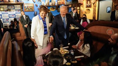 TOPSHOT - US President Joe Biden, alongside Maritza Rodriguez (in white), a campaign advisor for the Biden Nevada state team, greets people as he arrives at Lindo Michoacan restaurant ahead of a radio interview in Las Vegas, Nevada, on July 17, 2024.  (Photo by Kent Nishimura / AFP) (Photo by KENT NISHIMURA/AFP via Getty Images)