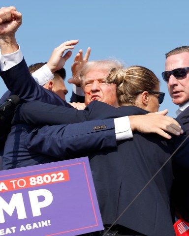 BUTLER, PENNSYLVANIA - JULY 13: Republican presidential candidate former President Donald Trump is rushed offstage during a rally on July 13, 2024 in Butler, Pennsylvania. (Photo by Anna Moneymaker/Getty Images)