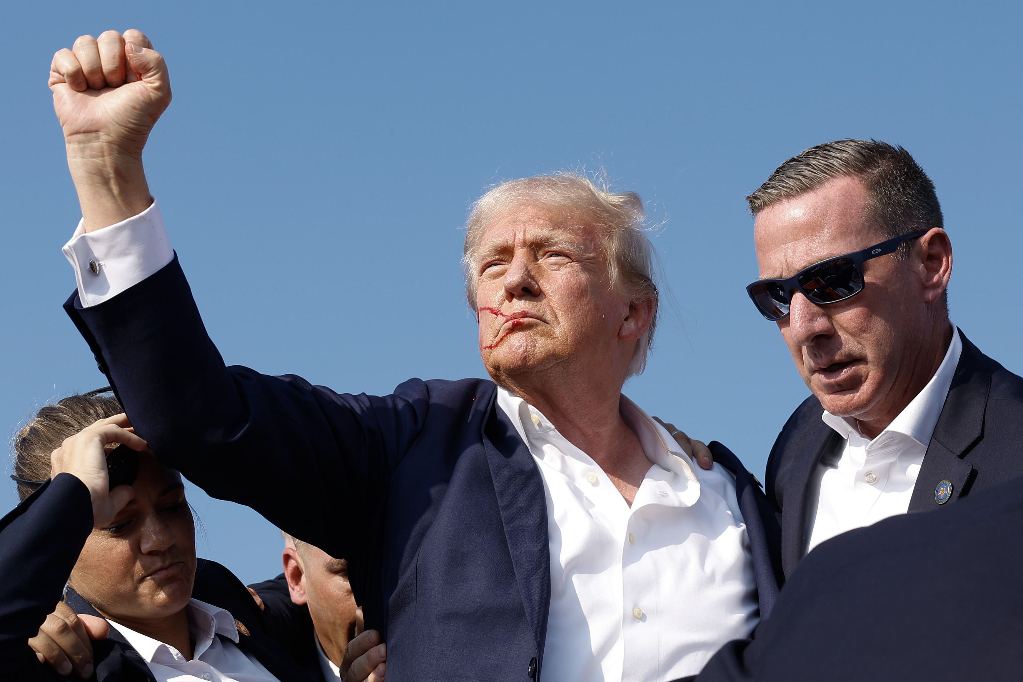 BUTLER, PENNSYLVANIA - JULY 13: Republican presidential candidate former President Donald Trump pumps his fist as he is rushed offstage during a rally on July 13, 2024 in Butler, Pennsylvania. (Photo by Anna Moneymaker/Getty Images)