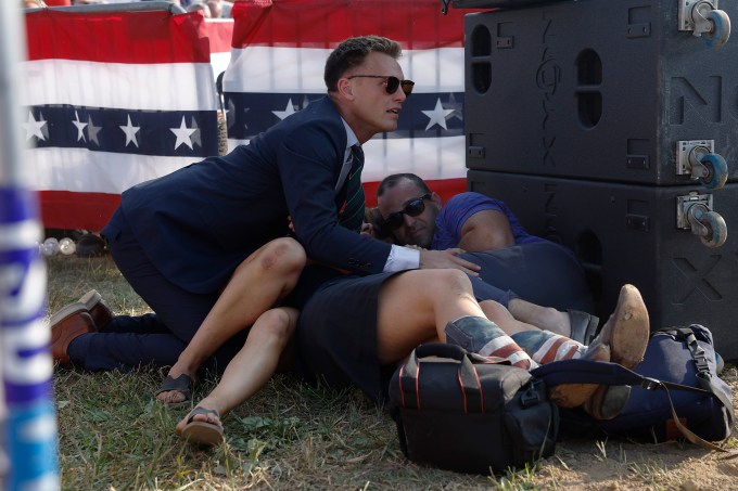 A Secret Service member and Trump supporters on the ground