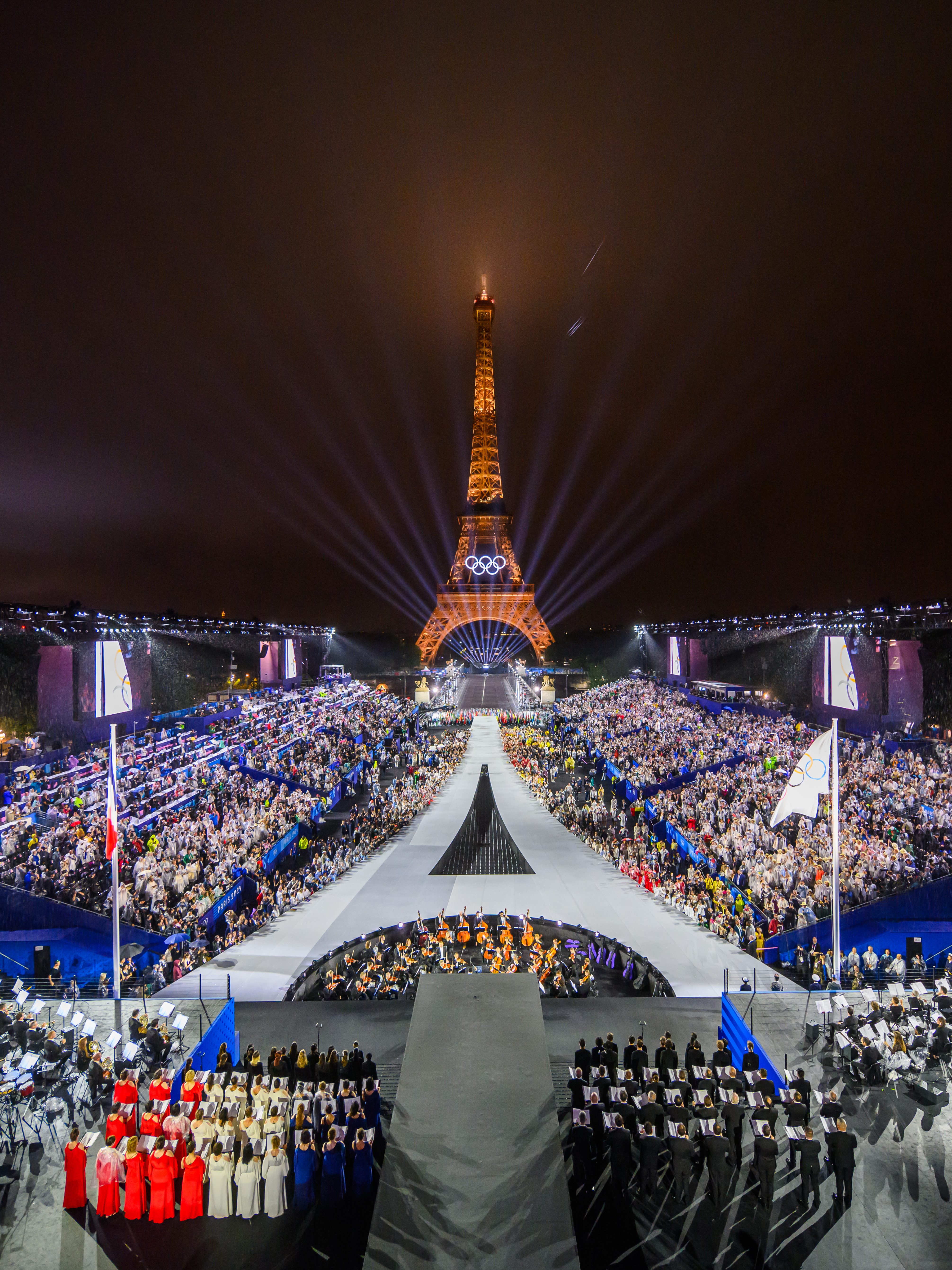 PARIS, FRANCE - JULY 26:  The Olympic flag is rasied at the Place du Trocadero in front of the Eiffel Tower during the Opening Ceremony of the Olympic Games Paris 2024 on July 26, 2024 in Paris, France. (Photo by François-Xavier Marit-Pool/Getty Images)