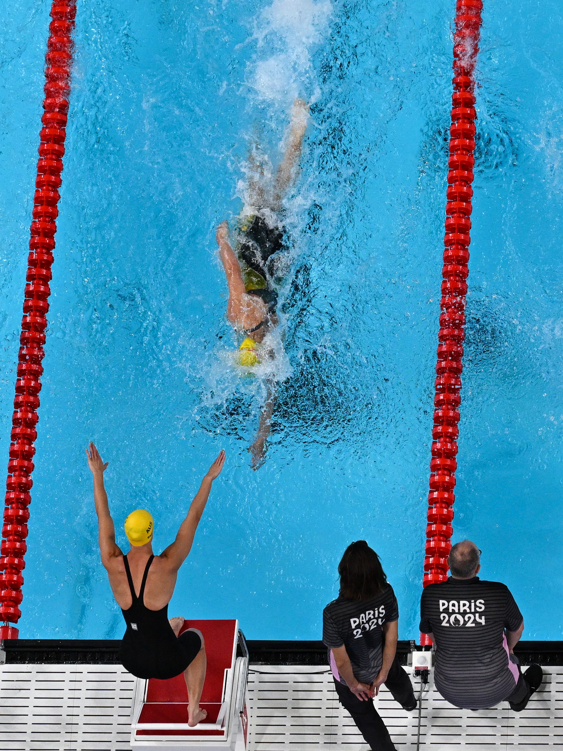 CORRECTION / An overview shows Australia's Bronte Campbell (lower C) competing in a heat of the women's 4x100m freestyle relay swimming event at the Paris 2024 Olympic Games at the Paris La Defense Arena in Nanterre, west of Paris, on July 27, 2024. (Photo by Manan VATSYAYANA / AFP) / "The erroneous mention[s] appearing in the metadata of this photo by Antonin THUILLIER has been modified in AFP systems in the following manner: Manan Vatsyayana] instead of [Antonin THUILLIER]. Please immediately remove the erroneous mention[s] from all your online services and delete it (them) from your servers. If you have been authorized by AFP to distribute it (them) to third parties, please ensure that the same actions are carried out by them. Failure to promptly comply with these instructions will entail liability on your part for any continued or post notification usage. Therefore we thank you very much for all your attention and prompt action. We are sorry for the inconvenience this notification may cause and remain at your disposal for any further information you may require." (Photo by MANAN VATSYAYANA/AFP via Getty Images)