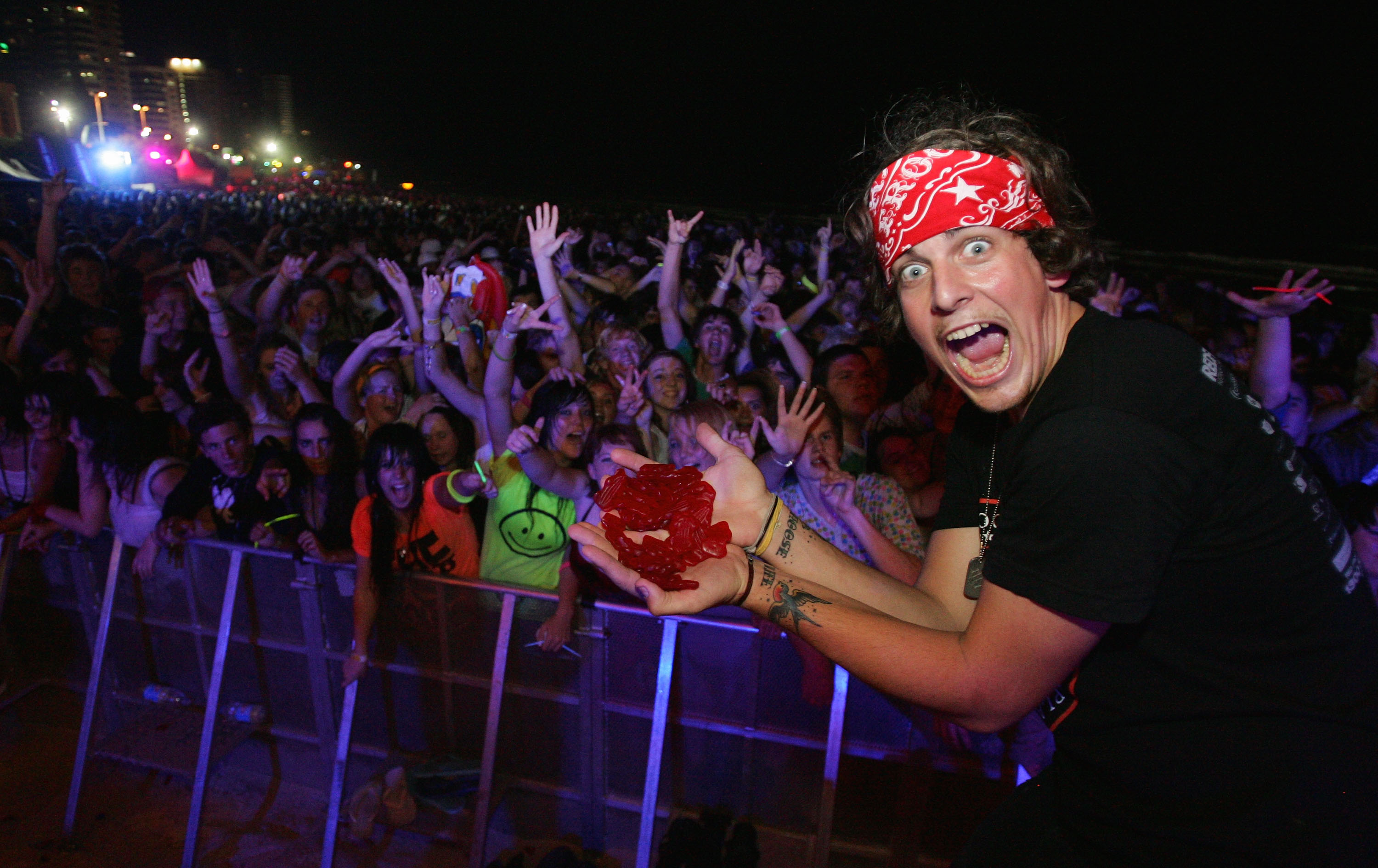 GOLD COAST, AUSTRALIA - NOVEMBER 17:  Graduating students party during the first Schoolies celebrations following the end of the year 12 exams, on Surfer's Paradise beach on November 18, 2007 on the Gold Coast, Australia. Schoolies is the annual celebration by year 12 students following the culmination of their HSC exams. The celebrations happen in several official locations throughout Australia, but the Gold Coast kicks off the celebrations as the Queensland exams finish ahead of all other states. This year sees a new fence erected daily for the night-time celebrations in an effort to stop gate crashers and non-Year 12 revellers.  (Photo by Sergio Dionisio/Getty Images)