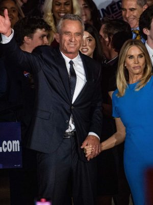 Robert F Kennedy Jr., with his wife Cheryl Hines, waves to supporters during a campaign event to launch his 2024 presidential bid, at the Boston Park Plaza in Boston, Massachusetts, on April 19, 2023. (Photo by JOSEPH PREZIOSO / AFP) (Photo by JOSEPH PREZIOSO/AFP via Getty Images)