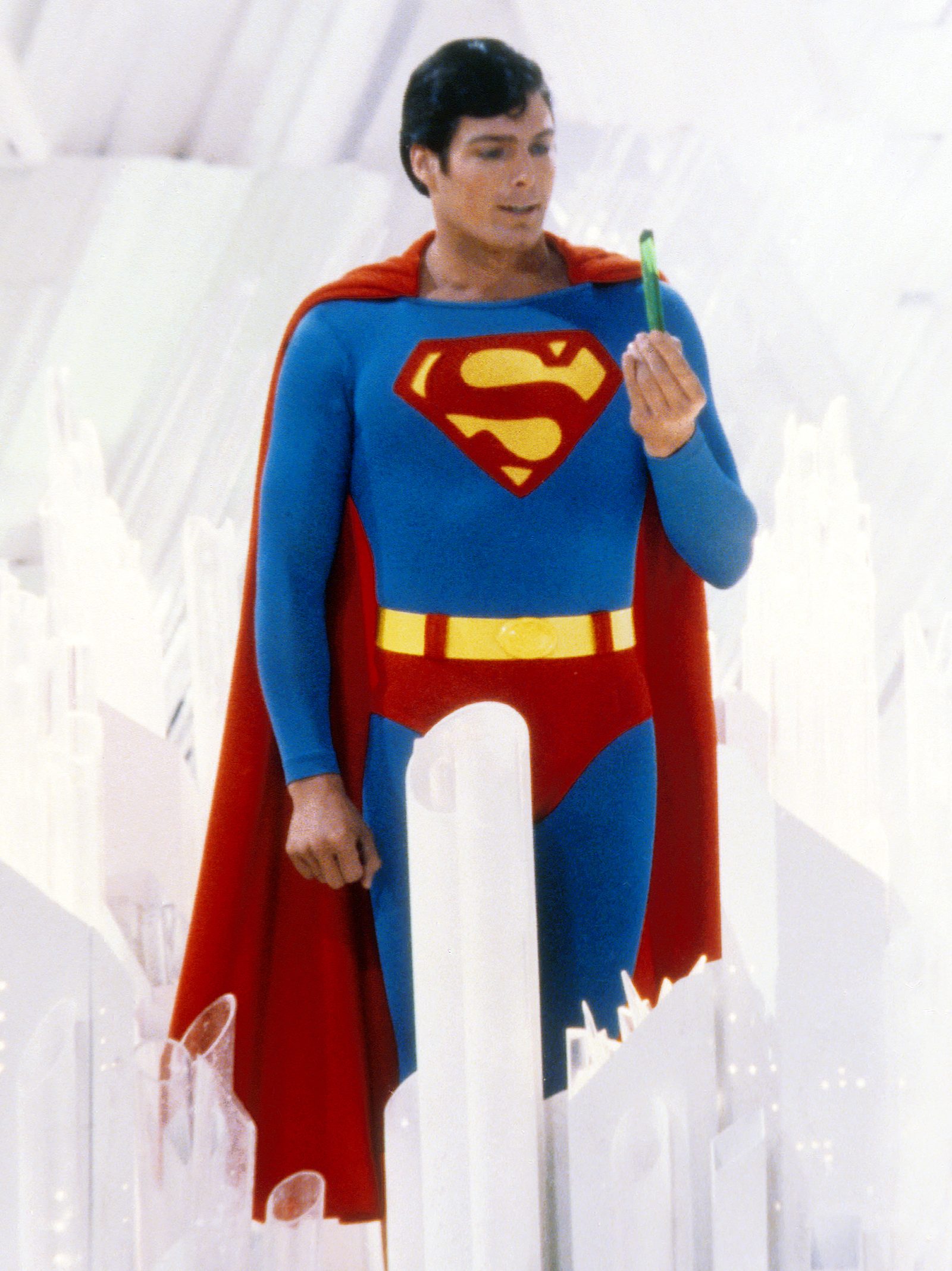 Superman, played by American actor Christopher Reeve (1952 - 2004), holds a green crystal at the Fortress of Solitude, in a promotional still from 'Superman', directed by Richard Donner, 1978. (Photo by Silver Screen Collection/Getty Images)