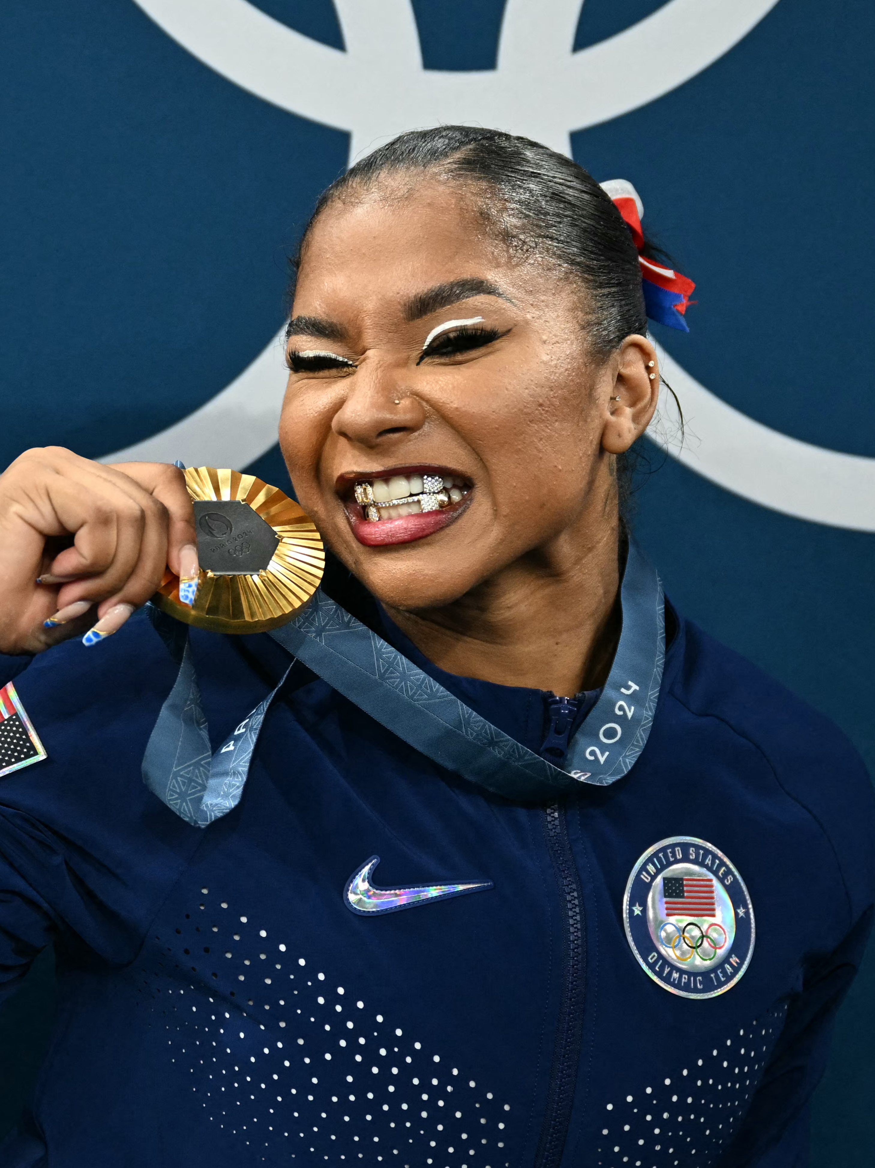 Jordan Chiles poses with the gold medal after the podium ceremony