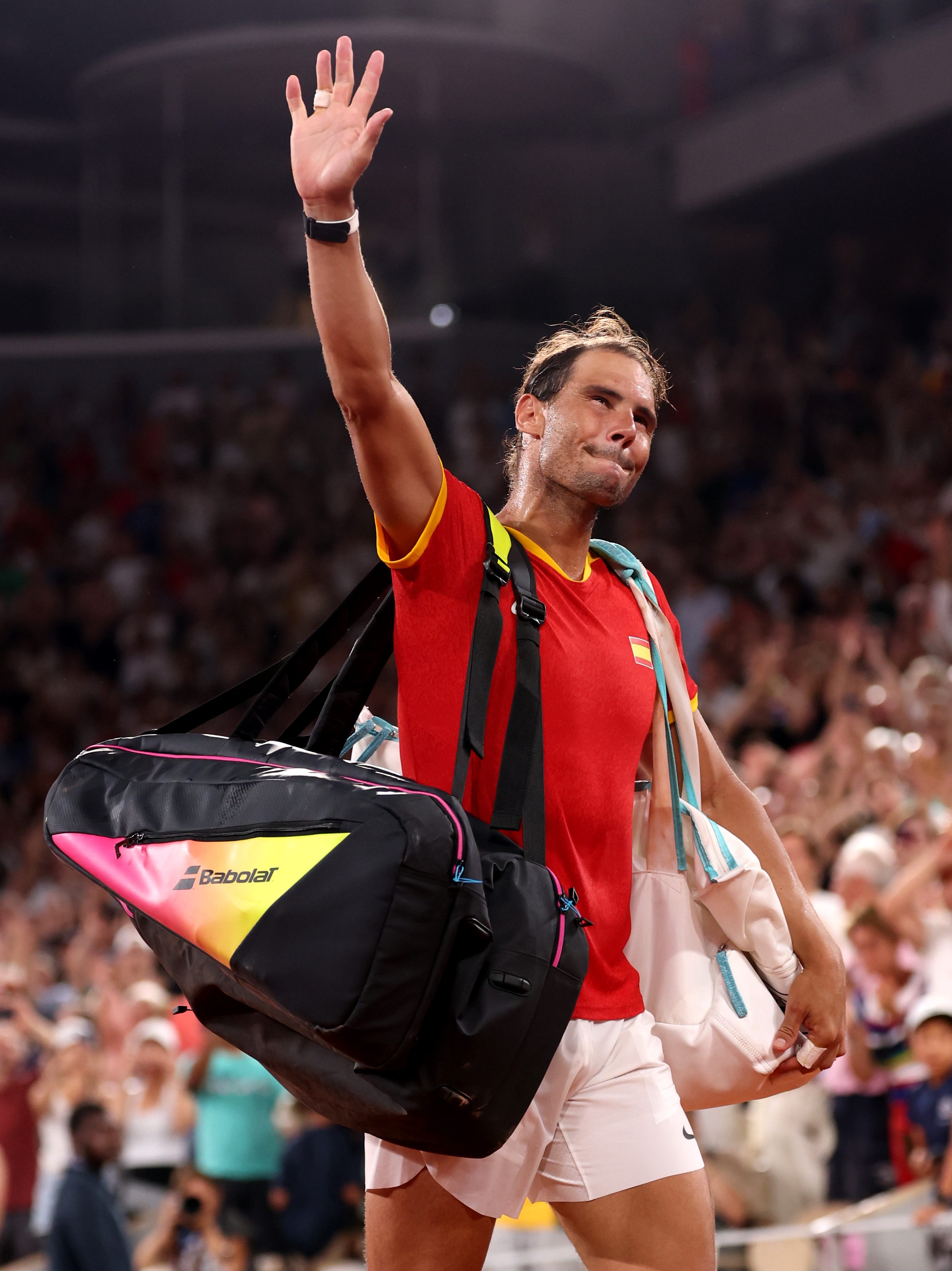 PARIS, FRANCE - JULY 31: Rafael Nadal of Team Spain acknowledges the crowd as he leaves the court with partner (out of frame) Carlos Alcaraz of Team Spain after their Men's Doubles Quarter-final match against Austin Krajicek of Team United States and Rajeev Ram of Team United States on day five of the Olympic Games Paris 2024 at Roland Garros on July 31, 2024 in Paris, France. (Photo by Julian Finney/Getty Images)