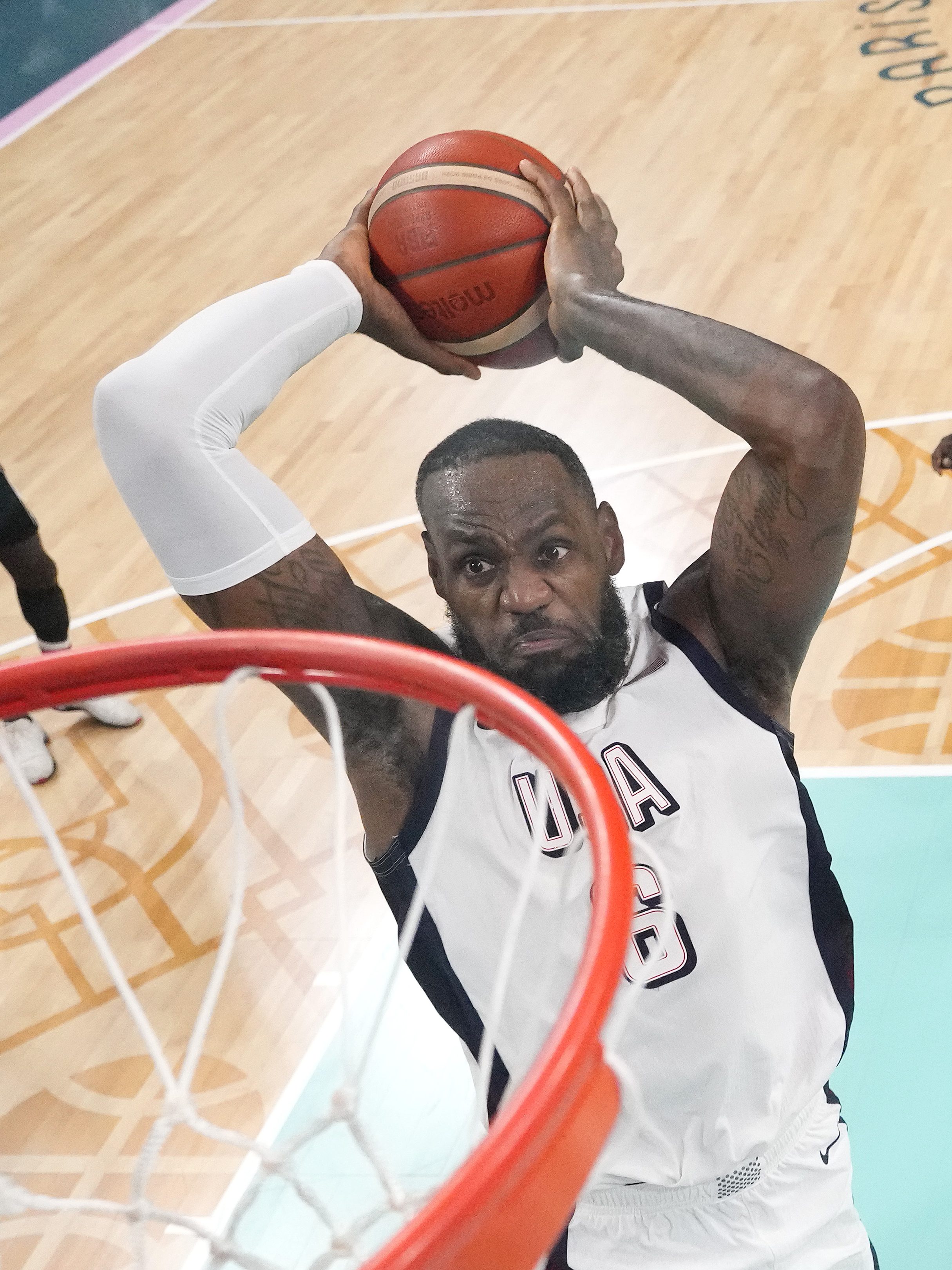 LILLE, FRANCE - JULY 31: (EDITORS NOTE: Image was captured using a remote camera positioned above the field of play) Lebron James #6 of Team United States goes up for a dunk during a Men's Group Phase - Group C game between the United States and South Sudan on day five of the Olympic Games Paris 2024 at Stade Pierre Mauroy on July 31, 2024 in Lille, France. (Photo by Pool/2024 Getty Images)