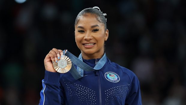 Jordan Chiles holding up her bronze medal