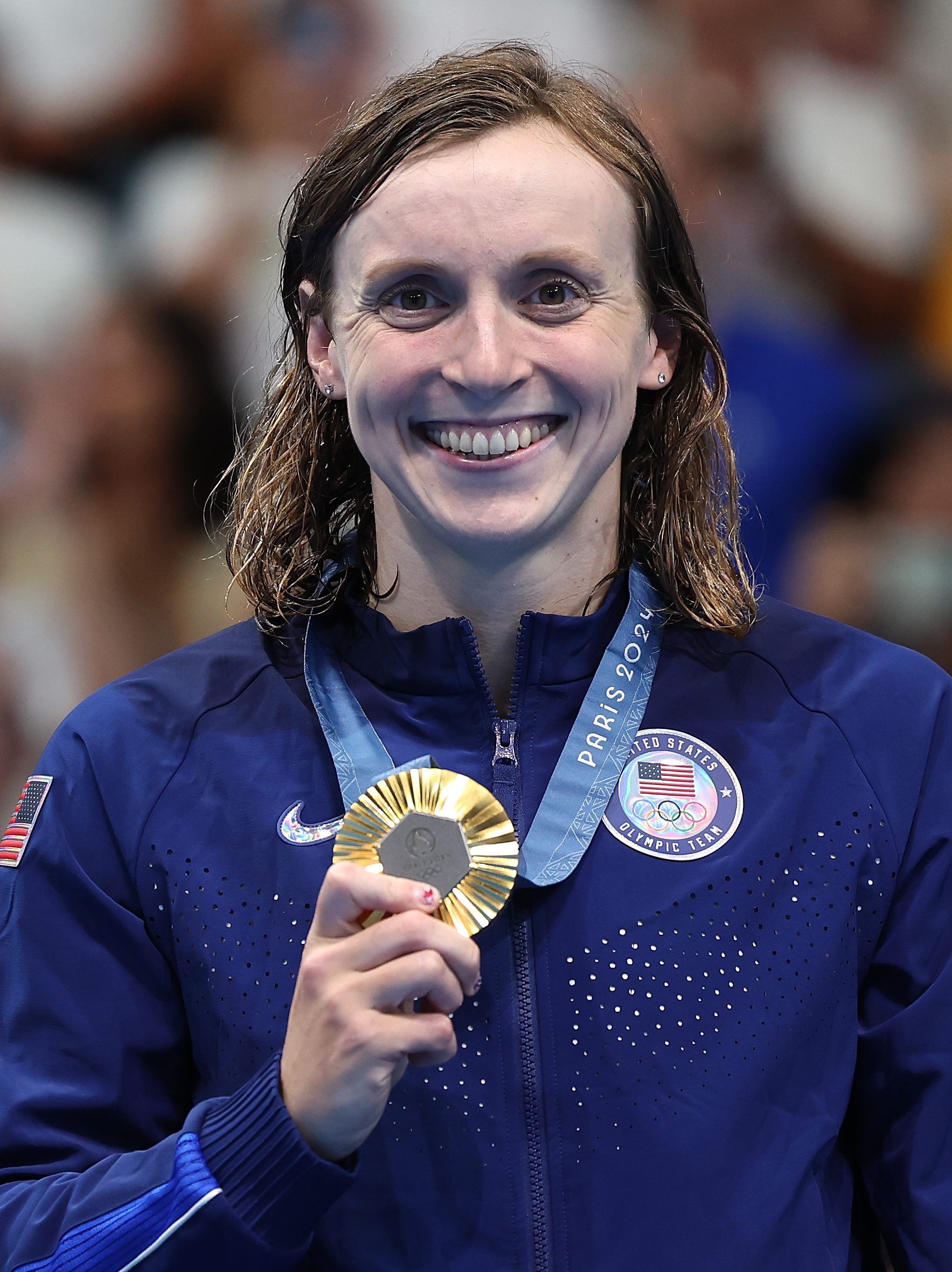 NANTERRE, FRANCE - AUGUST 03: Gold Medalist Katie Ledecky of Team United States poses on the podium during the Swimming medal ceremony after the Women's 800m Freestyle Final on day eight of the Olympic Games Paris 2024 at Paris La Defense Arena on August 03, 2024 in Nanterre, France. (Photo by Quinn Rooney/Getty Images)