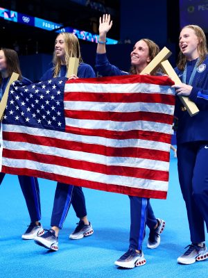 NANTERRE, FRANCE - AUGUST 04: Gold Medalists Regan Smith, Lilly King, Gretchen Walsh and Torri Huske of Team United States celebrate with the national flag of the United States following the Swimming medal ceremony after the Women’s 4x100m Medley Relay Final on day nine of the Olympic Games Paris 2024 at Paris La Defense Arena on August 04, 2024 in Nanterre, France. (Photo by Maddie Meyer/Getty Images)