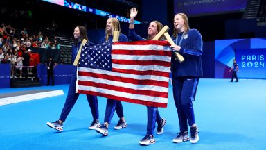 NANTERRE, FRANCE - AUGUST 04: Gold Medalists Regan Smith, Lilly King, Gretchen Walsh and Torri Huske of Team United States celebrate with the national flag of the United States following the Swimming medal ceremony after the Women’s 4x100m Medley Relay Final on day nine of the Olympic Games Paris 2024 at Paris La Defense Arena on August 04, 2024 in Nanterre, France. (Photo by Maddie Meyer/Getty Images)