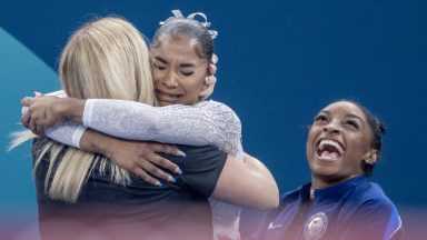 PARIS, FRANCE: AUGUST 05:  Jordan Chiles of the United States is congratulated by coach Cecile Landi and teammate Simone Biles of the United States after dramatically claiming the bronze medal on a score change after the Women's Floor Final during the Artistic Gymnastics competition at the Bercy Arena during the Paris 2024 Summer Olympic Games on August 5th, 2024 in Paris, France. (Photo by Tim Clayton/Corbis via Getty Images)