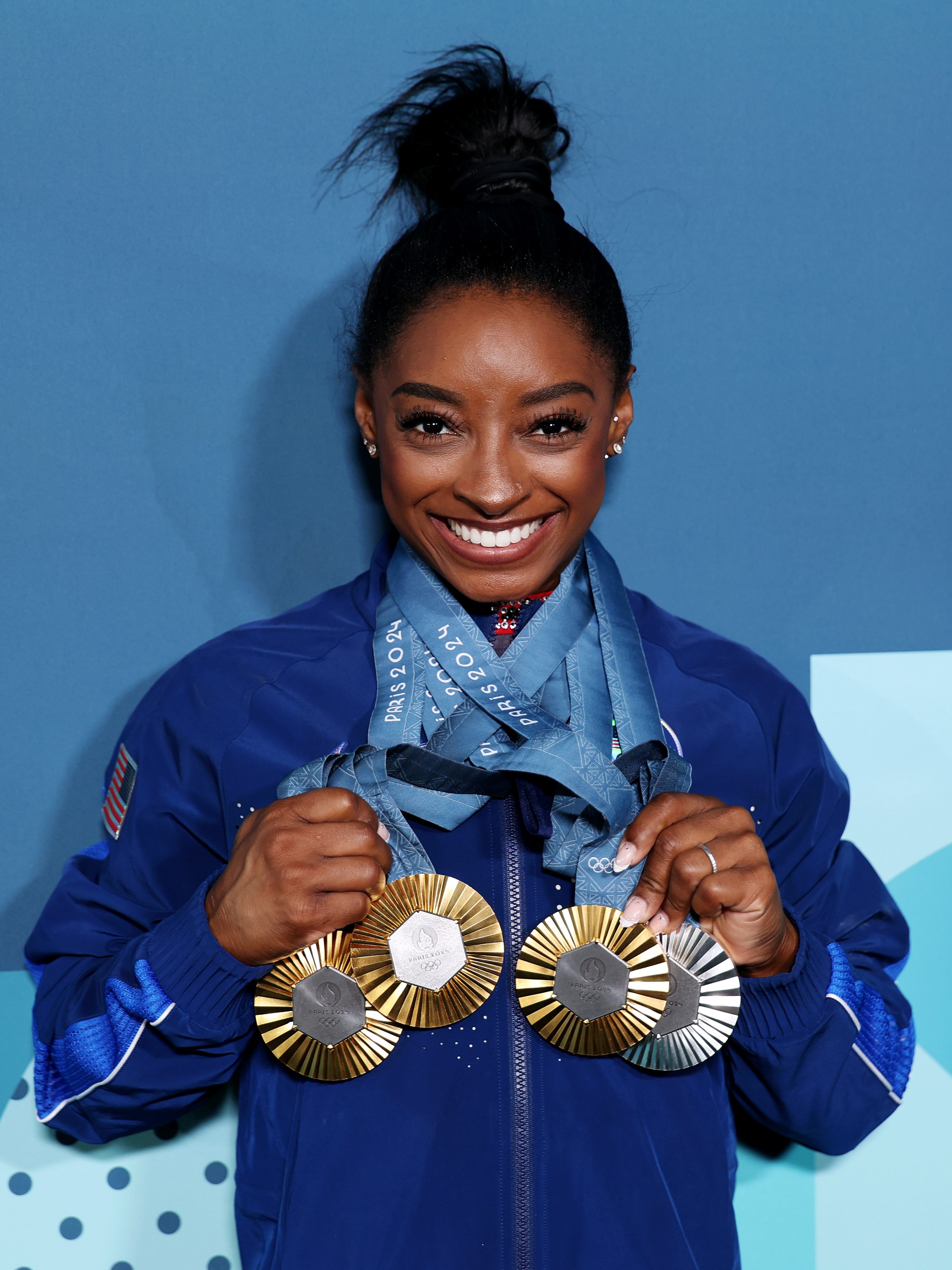 PARIS, FRANCE - AUGUST 05: Simone Biles of Team United States poses with her Paris 2024 Olympic medals following the Artistic Gymnastics Women's Floor Exercise Final on day ten of the Olympic Games Paris 2024 at Bercy Arena on August 05, 2024 in Paris, France. (Photo by Naomi Baker/Getty Images)