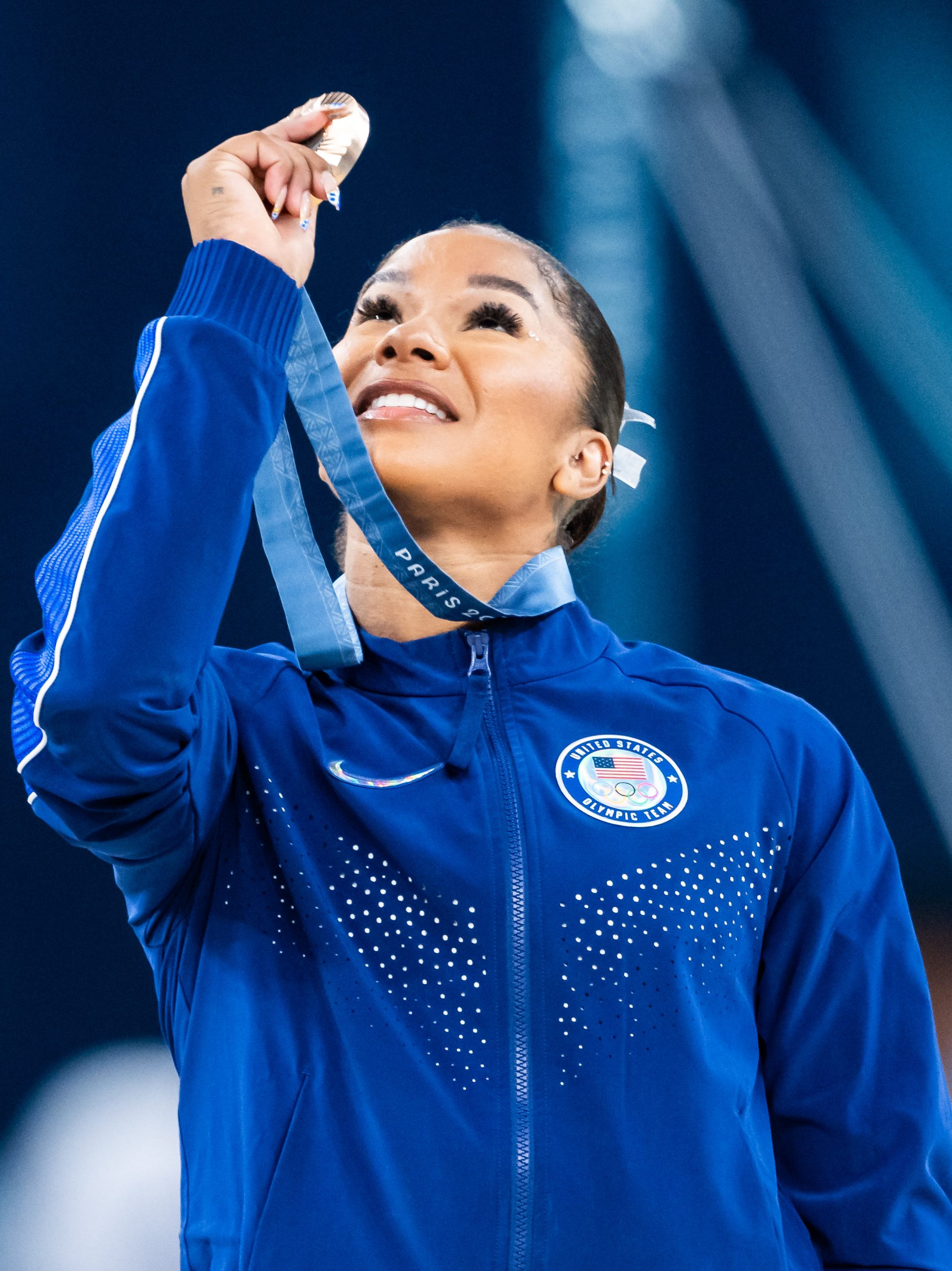 Jordan Chiles holds up the bronze medal at the 2024 Olympics