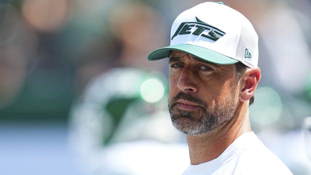 EAST RUTHERFORD, NEW JERSEY - AUGUST 10: Aaron Rodgers #8 of the New York Jets looks on against the Washington Commanders during the preseason game at MetLife Stadium on August 10, 2024 in East Rutherford, New Jersey. The Jets defeated the Commanders 20-17. (Photo by Mitchell Leff/Getty Images)