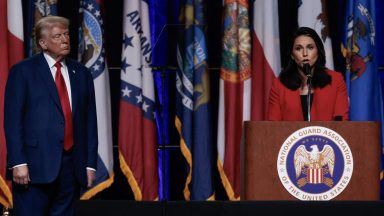 Donald Trump looks on as former US Representative Tulsi Gabbard endorses him