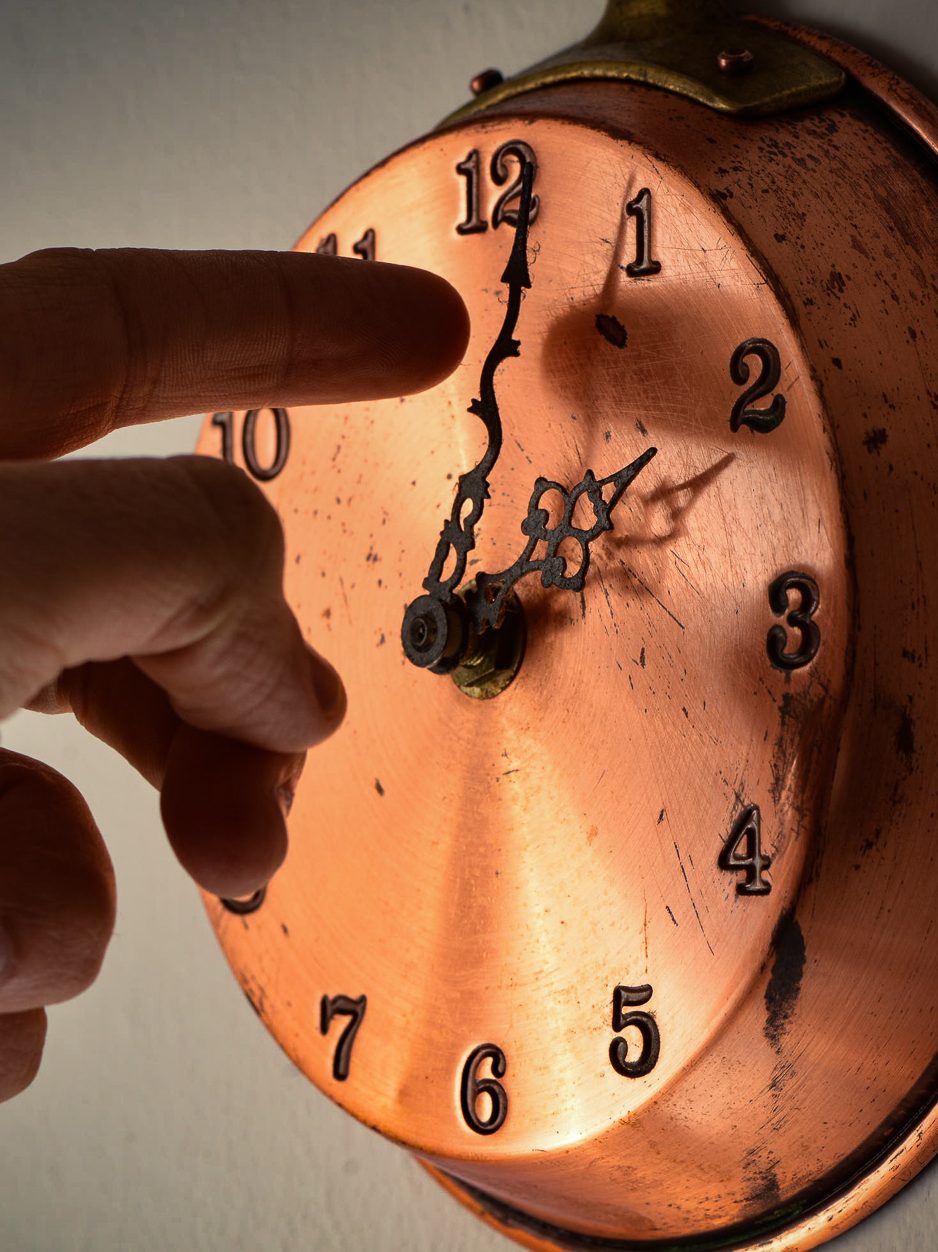 A man changing time on a clock is seen in LAquila, Italy, on March 24, 2023. On march 26th (last march sunday) solar time will replace daylight saving time and people around the world will move one hour ahead hands of clocks.  (Photo by Lorenzo Di Cola/NurPhoto via Getty Images)